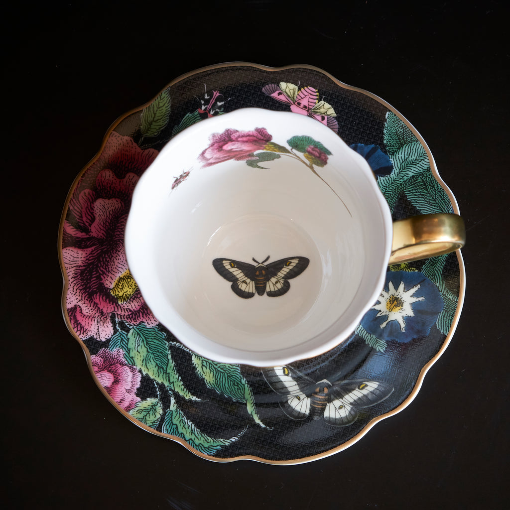 snake and dark floral teacup and saucer