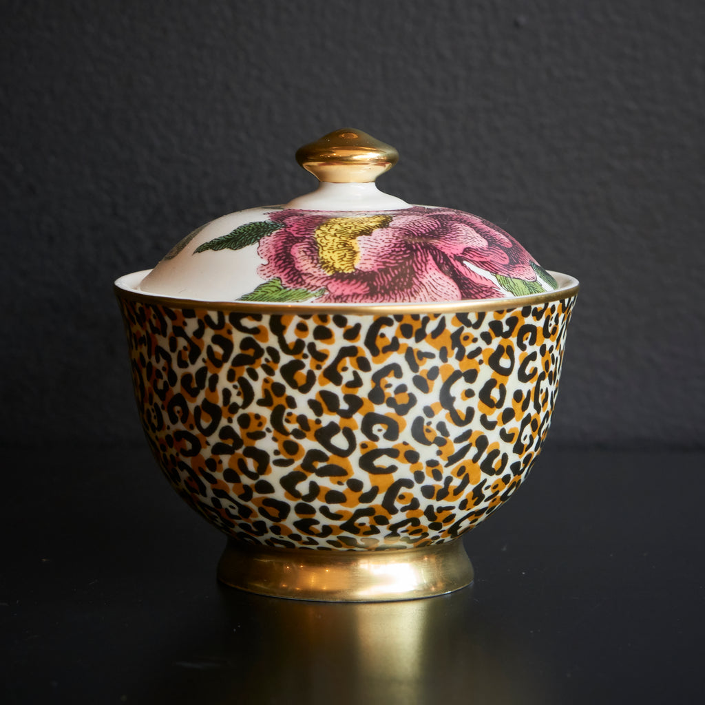 Sugar bowl with leopard print base and floral lid on a light background